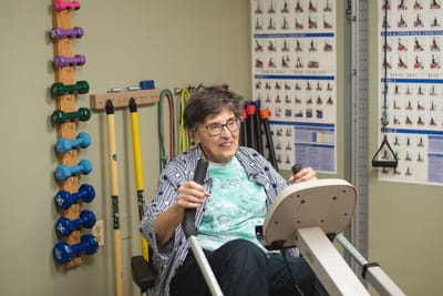 Resident using exercise equipment in a wellness room