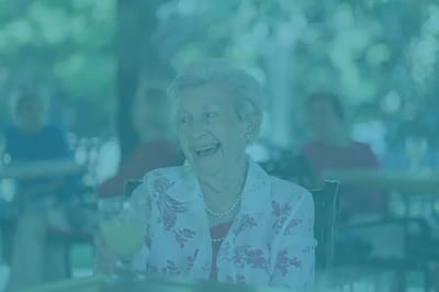 Elderly resident enjoying a drink outdoors