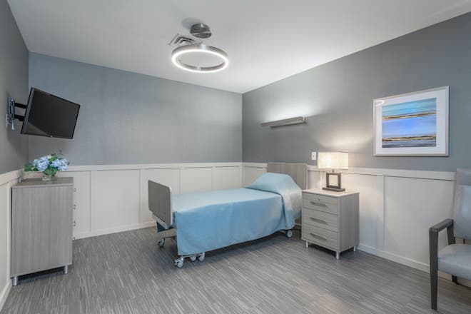 A well-furnished private resident room with bed and decor