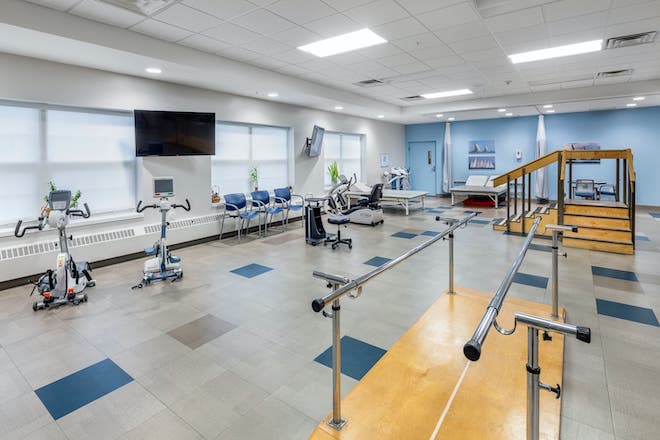 Interior view of a rehabilitation exercise room with equipment