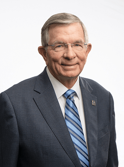 Portrait of a man in a suit with a blue tie