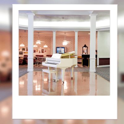 Interior view of a lobby with a grand piano.