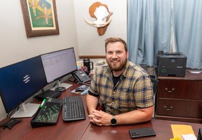 Staff member at a desk with computers