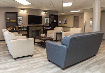 Cozy common area with seating and a fireplace.