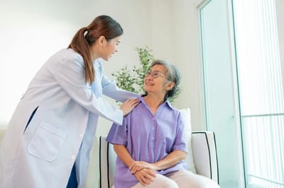 A caregiver interacting with a senior resident indoors