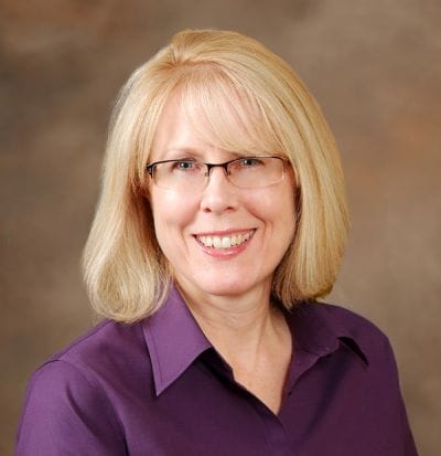 Dove Healthcare – Superior, Nursing Home in Superior, WI — Smiling woman with glasses in a professional setting