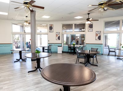 A bright common area with tables and chairs