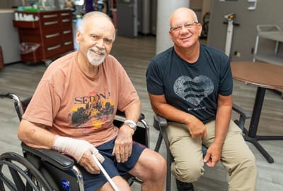 Two men smiling in a common area of the facility