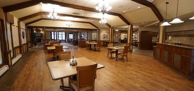 Interior view of a spacious common area with tables and chairs