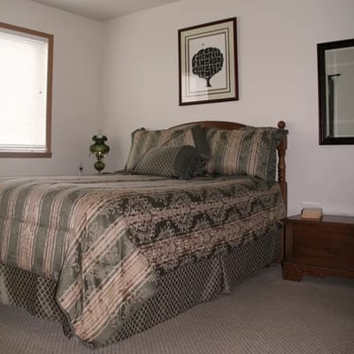 Cozy bedroom with patterned bedding and artwork