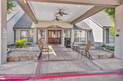 Front entrance of Tomball Retirement Center with outdoor seating