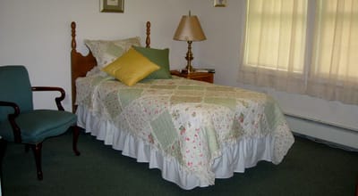 Cozy resident room with bed and lamp
