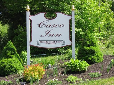 Sign of Casco Inn Residential Care Facility surrounded by greenery