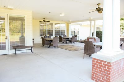 Covered outdoor seating area with tables and chairs