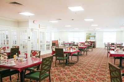 Dining room with tables set for residents