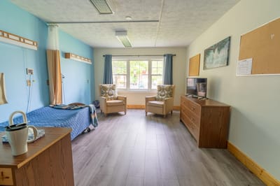 Private resident room with seating and natural light