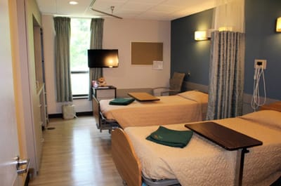 Private resident room with two beds and amenities