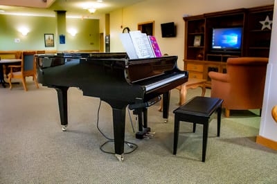 A black grand piano in a common area