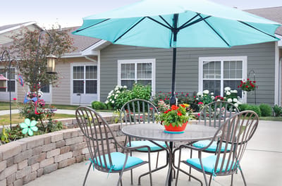Outdoor seating area with flowers and umbrella