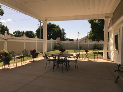 Outdoor seating area with tables and flowers