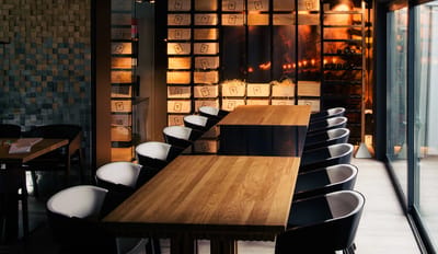 Interior dining area with a long wooden table and chairs