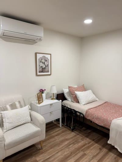 Cozy resident room with a bed and chair