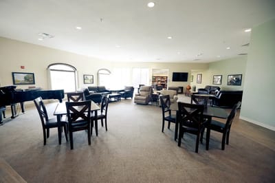 Common area with seating and piano in a senior living community