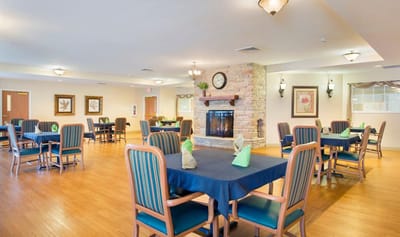 Brightly lit dining room with tables and chairs