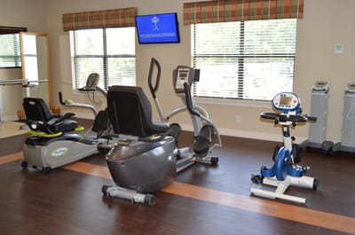 Facility gym equipment in a well-lit room
