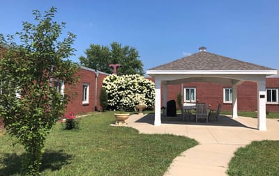 Outdoor gazebo area with seating and landscaping