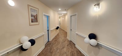 Brightly lit hallway decorated with balloons and artwork