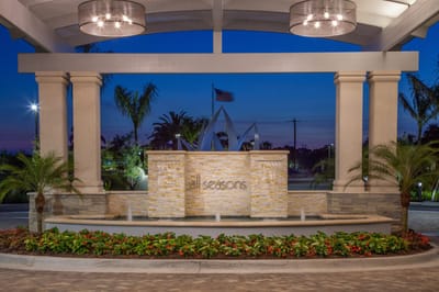 Exterior view of All Seasons Naples entrance at dusk