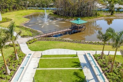 Aerial view of a landscaped outdoor space with a pond and gazebo