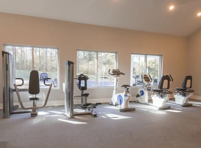Equipment in a fitness area with large windows