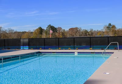 Outdoor pool area with clear blue water