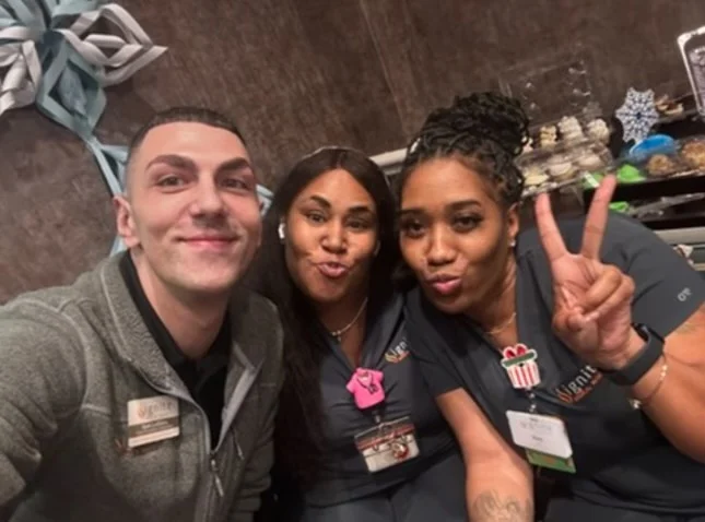 Staff members taking a playful selfie together
