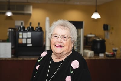 Smiling resident in a cozy interior setting