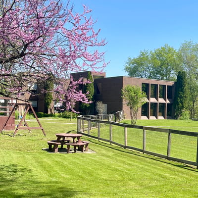 Outdoor view of a senior living facility with trees and open space