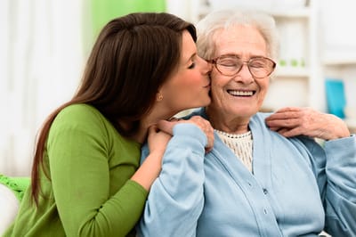 A caregiver sharing a joyful moment with a resident