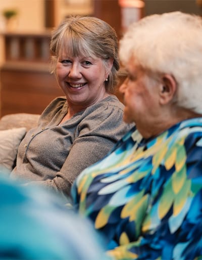 Fairway Knoll, assisted living in Germantown, WI — Residents engaging in conversation in a comfortable lounge