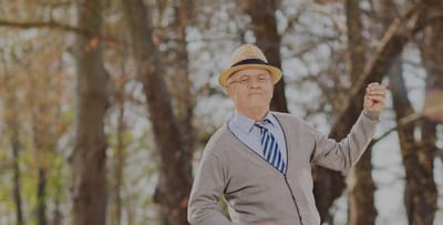 A resident enjoying a sunny day outdoors with a straw hat