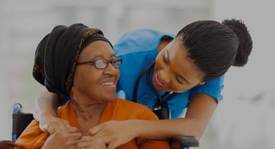 Caregiver smiling with a resident in a facility setting