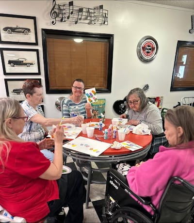 Residents engaging in a painting activity indoors