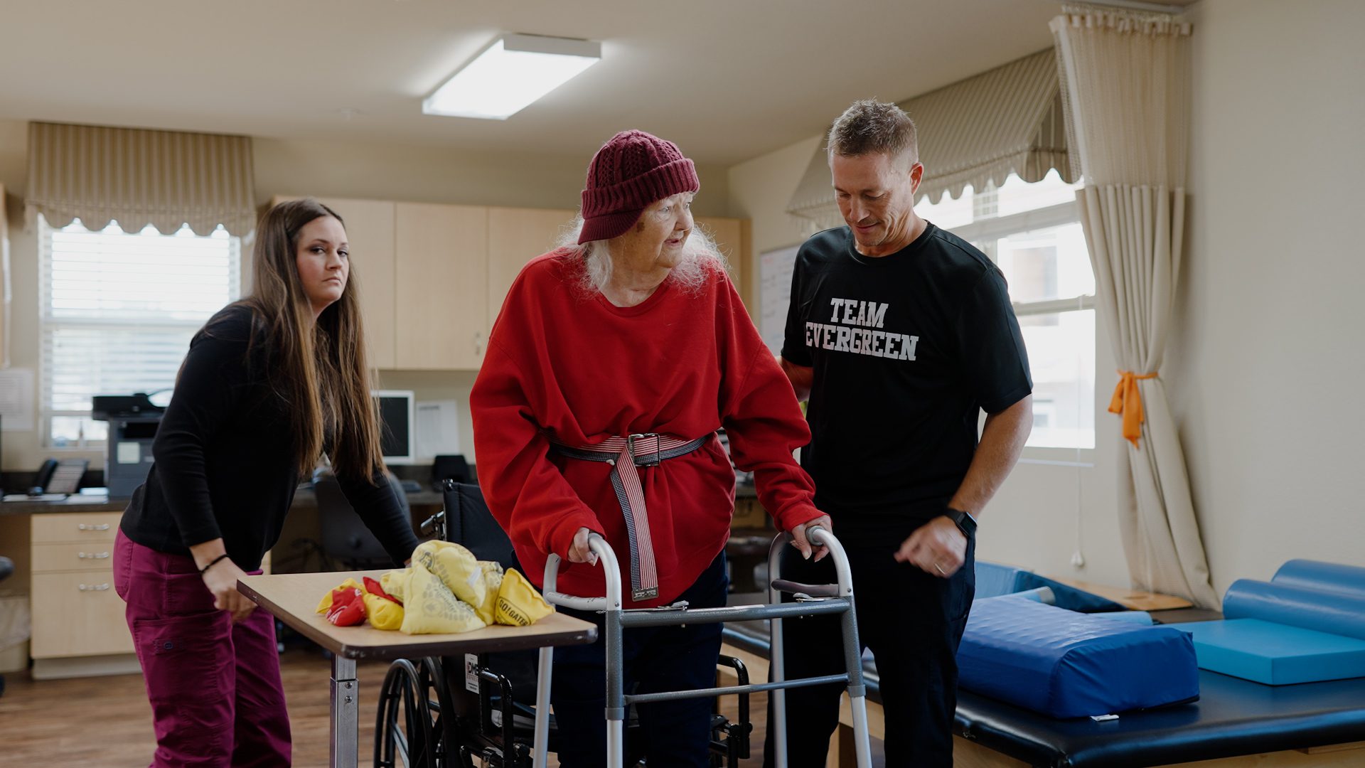 Staff assisting a resident during rehabilitation.