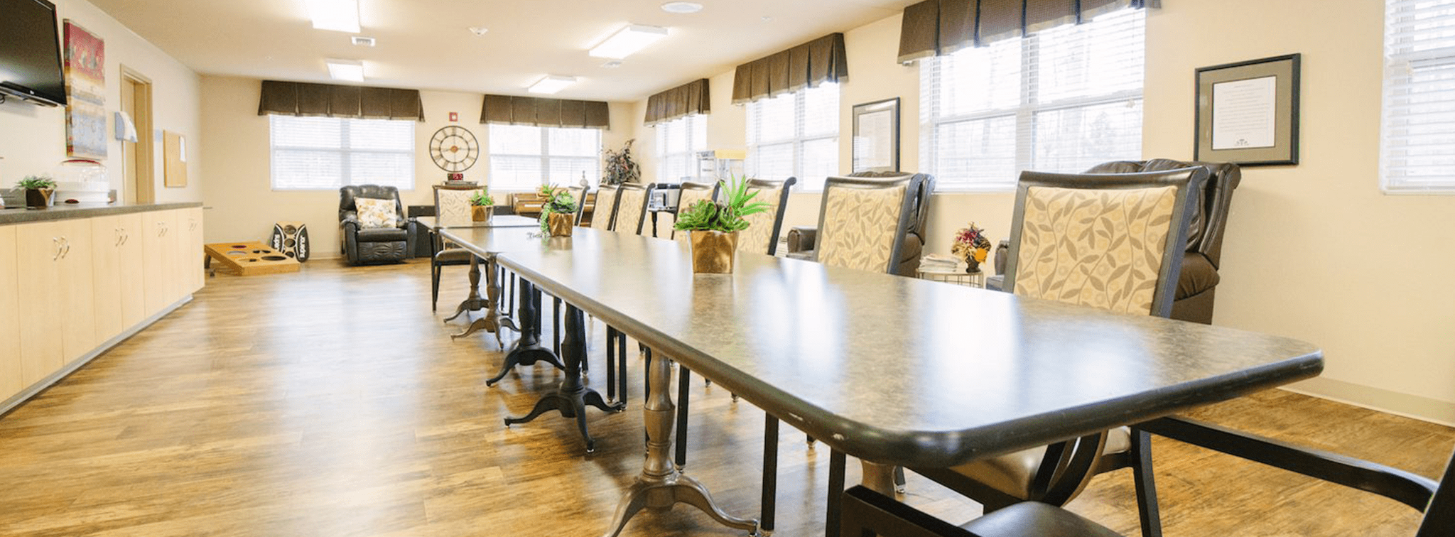 Bright activity room with long table and comfortable chairs