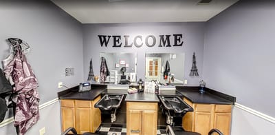 Interior view of a hair salon with welcome sign