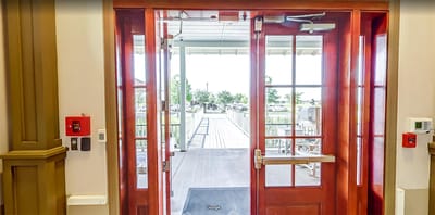 Entrance doors leading to an outdoor area