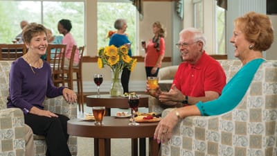 Residents enjoying drinks and snacks in a common area