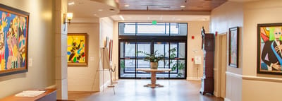 Bright interior hallway with artwork and plants