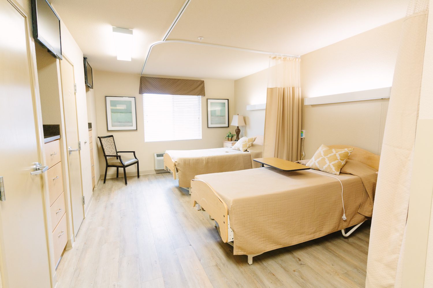 A neatly arranged shared resident room with two beds